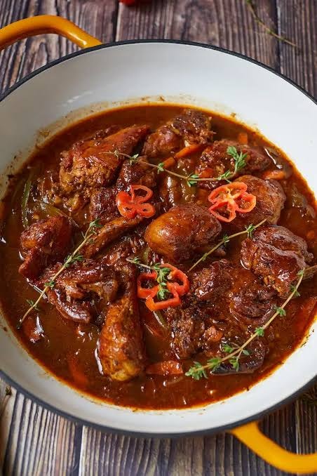 Braised oxtail in rich tomato sauce with thyme and scotch bonnet